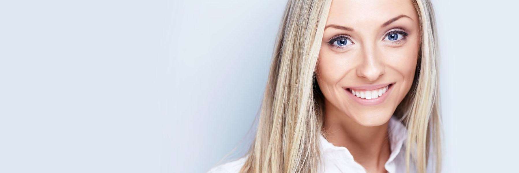 Confident woman smiling with healthy teeth after dental implant treatment