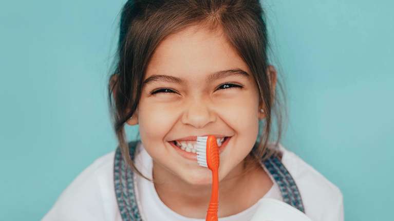 young girl happily brushing her teeth in highgate hill